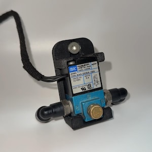 May include: A blue and black solenoid valve with a label that reads "MAC Model 35A-AAA-DDBA-1BA Volts/Hz 12 VDC Watts 5.4 VAC to 120 PSI".