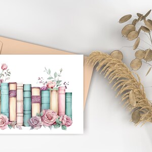 May include: A watercolor illustration of a stack of vintage books with floral accents. The books are in shades of blue, pink, and cream, and the flowers are in shades of pink and white.