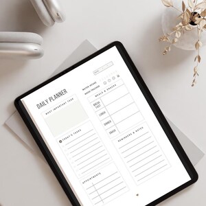 May include: A digital daily planner on a tablet screen. The planner includes sections for a most important task, today's tasks, appointments, water intake, mood tracker, meals and snacks, and reminders and notes.