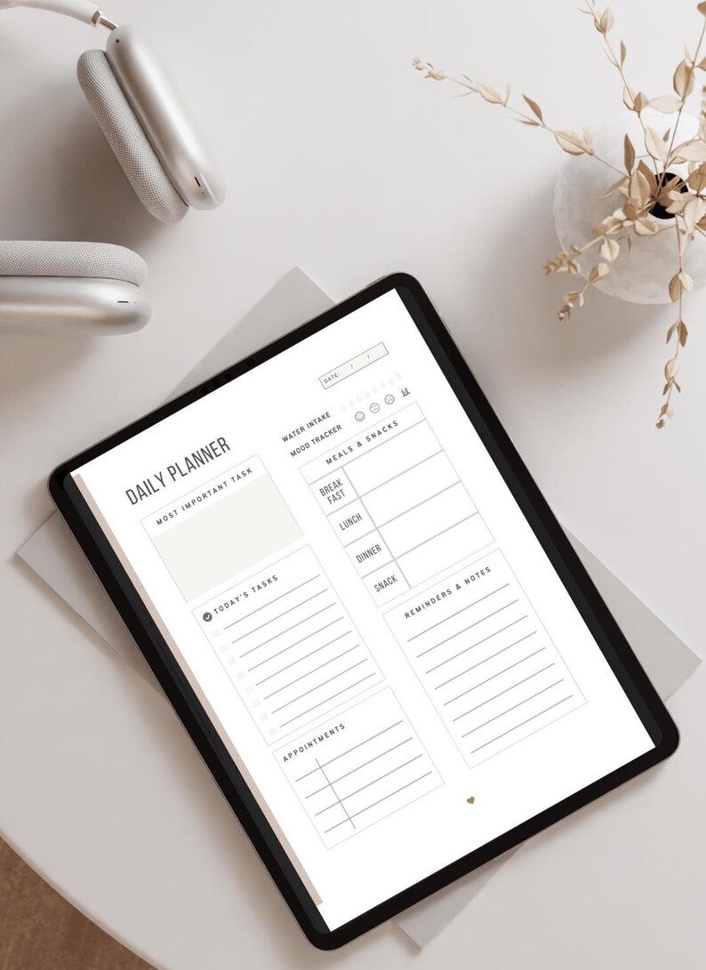 May include: A digital daily planner on a tablet screen. The planner includes sections for a most important task, today's tasks, appointments, water intake, mood tracker, meals and snacks, and reminders and notes.