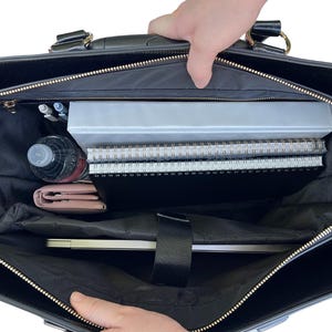 Interior of the professional women’s rolling tote bag filled with laptop, folders, pens, charger, planner, and a water bottle. Designed for commuting women who want function and style, this work tote with wheels makes packing easy. Use it as a wheeled carry-on for weekend trips or a stylish mobile office for meetings. An ideal chic practical gift for her for Mother’s Day, birthdays or career milestones. Also makes a perfect book bag for grad school textbooks or as a stylish bible bag for church.