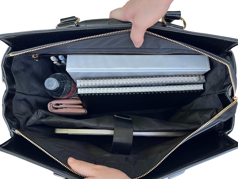Interior of the professional women’s rolling tote bag filled with laptop, folders, pens, charger, planner, and a water bottle. Designed for commuting women who want function and style, this work tote with wheels makes packing easy. Use it as a wheeled carry-on for weekend trips or a stylish mobile office for meetings. An ideal chic practical gift for her for Mother’s Day, birthdays or career milestones. Also makes a perfect book bag for grad school textbooks or as a stylish bible bag for church.