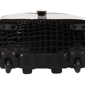 Bottom of the women’s wheeled laptop tote showing sturdy black all-terrain wheels and a reinforced base. Two front feet prevent the bag from tipping when letting go of the handle. A stylish professional laptop bag for travel, this rolling work bag for women glides easily through airports or office buildings. Use as a legal briefcase on wheels or a doctor’s rolling tote. Designed for everyday wear, it makes the perfect back-friendly gift for nurses, teachers, executives or busy women on the move.