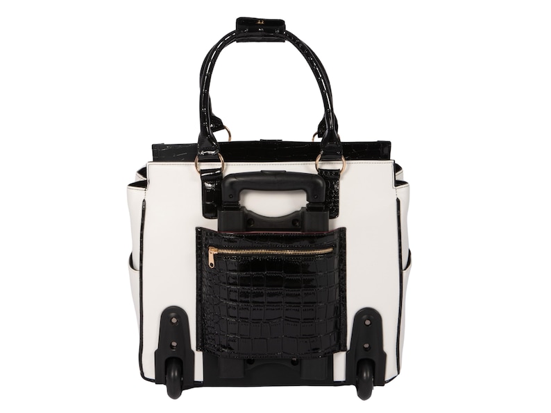 Back view of a wheeled work tote in white and black patent faux leather, featuring a retractable handle hidden in a zippered compartment providing easy access to chargers, phone, or passport. This rolling office bag for women is perfect for teachers, lawyers, or busy professionals on the go. Makes a great gift for working moms or travelers who need a rolling computer bag that’s both durable and elegant. Smooth-rolling all-terrain wheels make this the best women’s laptop bag for travel and work.
