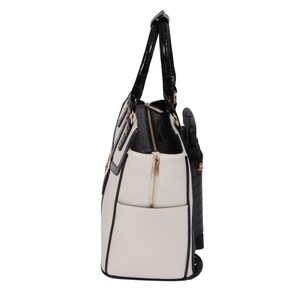 Side profile of a women’s laptop bag on wheels in white and black with croc-trim and deep side pockets and expandable zipper option. This stylish carry-on or weekender with wheels for women is ideal for daily commutes, weekend trips, or conventions. Use it as a nursing school bag, flight attendant roller bag, or fashionable laptop rolling briefcase. A great gift for her, this travel tote with wheels helps eliminate shoulder strain by putting your essentials on wheels and adds effortless style.