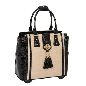 May include: Black and beige rolling tote bag with a gold tassel and a gold accent on the front.
