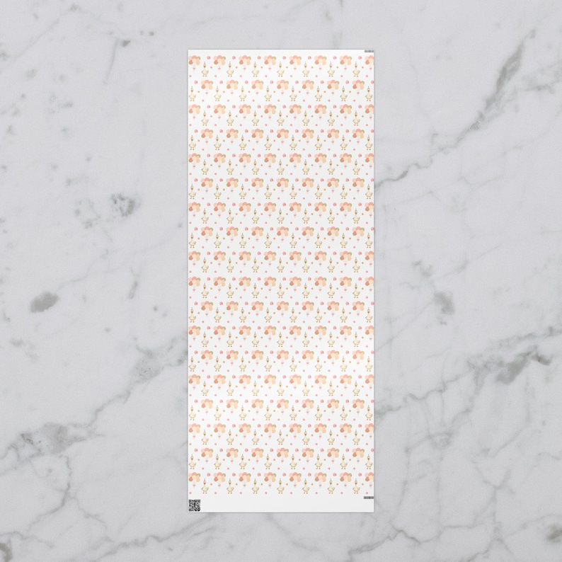 May include: A rectangular white fabric with a repeating pattern of small, stylized flowers in peach and gold, interspersed with tiny pink and blue dots. The design is delicate and feminine, creating a soft, watercolor effect.