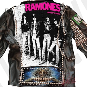 May include: Black leather jacket with silver studs and patches. The back of the jacket features a Ramones "Rocket to Russia" album cover patch and a black and white Iron Maiden patch.