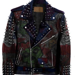 May include: A black leather jacket with silver studs and a Union Jack print. The jacket has a zipper closure and a belt at the waist. The jacket has a variety of band names and logos printed on it, including "The Killers" and "Plan B".