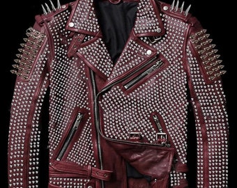 May include: A burgundy leather jacket with silver studs and spikes. The jacket has a zipper closure and a belt at the waist.