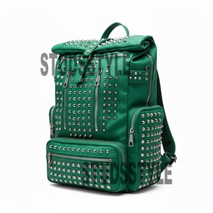May include: Green backpack with silver-colored studs and multiple zippered compartments. The backpack has a top handle and adjustable straps. The word "STYLE" is partially visible on the left side of the bag.