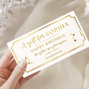May include: A rectangular white gift voucher with a gold foil border and gold star accents. The text reads: A gift for SOPHIA, HAPPY BIRTHDAY, The golden spa getaway pass, Love HUDSON. The design features elegant gold typography and decorative lines.