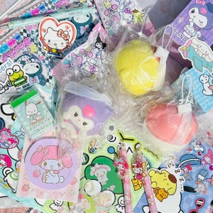 May include: A collection of colorful kawaii-themed items, including a pink and purple squishy, a yellow squishy, a pink and white squishy, a My Melody sticker, a Pochacco Peninsula Diary, a My Melody coaster, and a variety of pens and stickers.