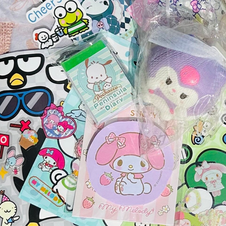 May include: A collection of colorful stickers and stationery featuring popular Japanese characters like My Melody and Pochacco. The stickers include a variety of designs, including a penguin with sunglasses, a cupcake, and a heart with wings. The stationery includes a notepad with a green cover and a pink and purple circular notepad with a My Melody design.