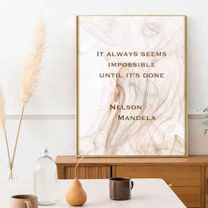 May include: A motivational quote by Nelson Mandela printed on a beige and white abstract art print. The quote reads "It always seems impossible until it's done."