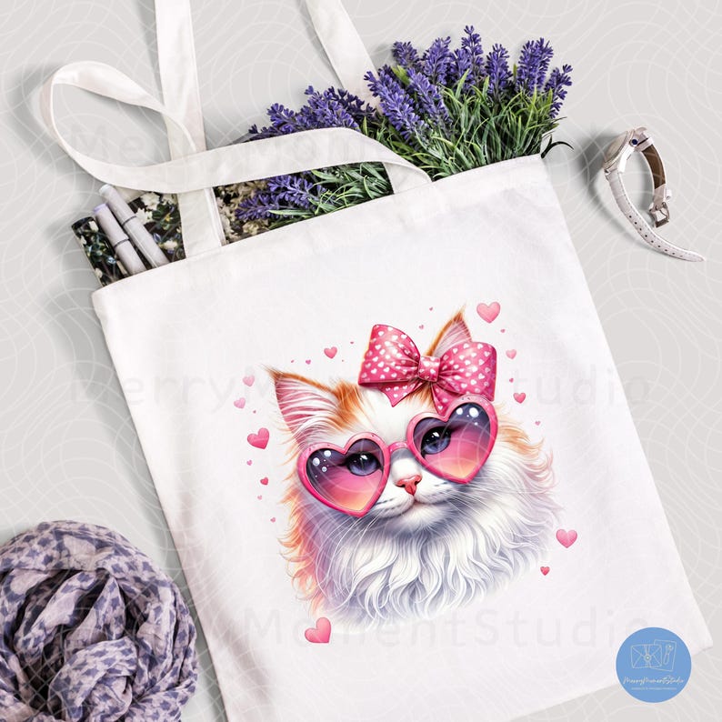 May include: White tote bag with a pink and white cat wearing heart-shaped sunglasses and a pink bow with white polka dots. The cat is surrounded by pink hearts.