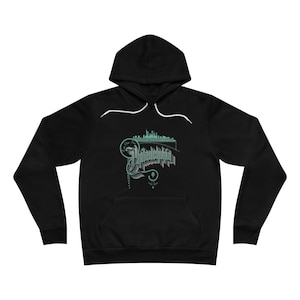May include: Black hooded sweatshirt with a green graphic of the Philadelphia skyline and the word "Philadelphia" in a stylized font.