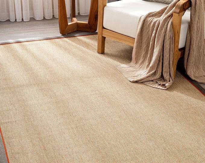 The natural-toned base color sisal-woven carpet with brown-orange double-toned borders is suitable for kitchens, living rooms, or farmhouses
