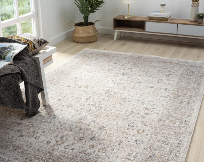 A beige colored, stain-resistant, thin and dense woven carpet suitable for traditional and modern styles.