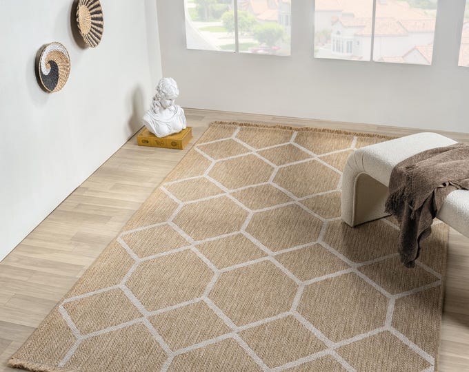 Honeycomb patterned white stain-resistant jute rug.