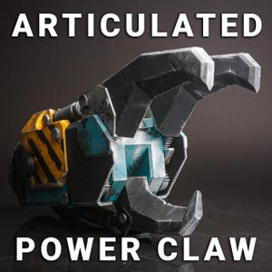 May include: An articulated power claw prop with a weathered, industrial aesthetic. The claw features a combination of black, blue, and yellow paint, with the text "ARTICULATED" and "POWER CLAW" in white.