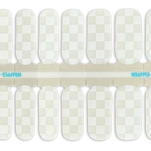 May include: A set of 10 white nail wraps with a checkered pattern. The wraps are designed to be applied over nail polish and are packaged in a clear plastic sheet with the text "WRAPPED 4 U POLISH" printed on it.
