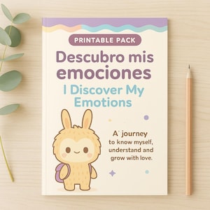 Puede incluir: Un libro infantil titulado "Descubro mis emociones I Discover My Emotions" con una ilustración de conejo de dibujos animados. El libro tiene una portada morada y blanca y un lápiz está colocado en el lado derecho.