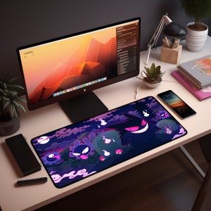 May include: A black and purple gaming mouse pad with a graphic of a cartoon ghost character. The character is smiling and has a purple glow. The background is a dark blue with clouds and a full moon.
