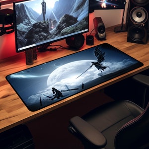 May include: A long, rectangular gaming mouse pad featuring a fantasy scene with a large moon, clouds, and figures with swords. The color palette is primarily blue, black, and white. The mouse pad is on a wooden desk.