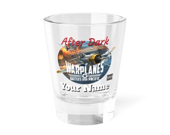 May include: A clear glass shot glass with a colorful graphic of a plane flying over a carrier deck. The graphic includes the text "After Dark", "Warplanes", "Battles Over Pacific", and "Your Name".