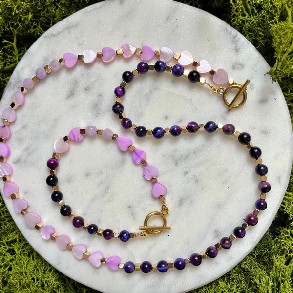 Set  necklace with bracelet. pink and purple tones and with gold finish.pink heart and natural purple, tiger eyes beads .
