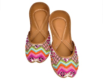 May include: A pair of flat, brown leather shoes with colorful embroidery and mirror embellishments. The embroidery features a chevron pattern in shades of pink, orange, green, and blue.