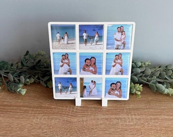 May include: A white square photo display frame featuring a grid of nine individual square tiles, each displaying a different photograph of people in white clothing on a beach. The frame has a clean, simple design with a stand at the bottom.