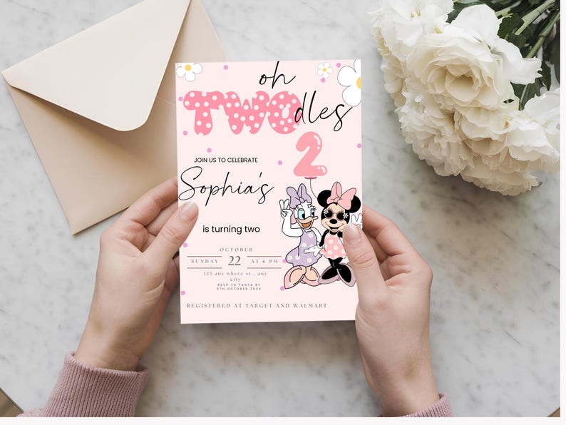 May include: A pink invitation card with the text "oh Twodles" and "Sophia's is turning two". The card features illustrations of Minnie and Daisy Mouse, with a pink number 2 balloon. The invitation is held by hands.