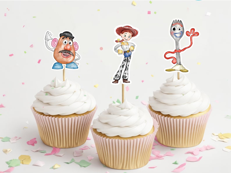 May include: Three cupcakes with white frosting and pink liners. Each cupcake has a different character from the Toy Story movie on top: Mr. Potato Head, Jessie, and Forky.