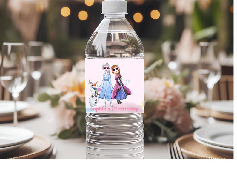 May include: A clear plastic water bottle with a pink label featuring cartoon characters from the movie Frozen. The label includes the text "Sophia's 2nd birthday". The bottle is on a table set for a party.