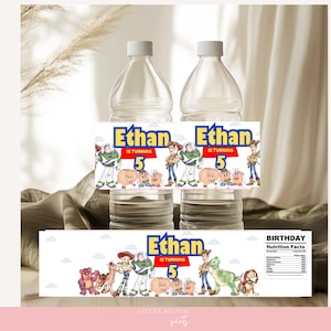 May include: Two clear plastic water bottles with custom labels. The labels feature the text "Ethan is turning 5" and cartoon characters. The labels include images of Woody, Buzz Lightyear, and other Toy Story characters. A third label is also visible.