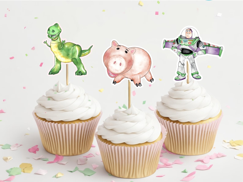 May include: Three cupcakes decorated with Toy Story characters. The cupcakes are topped with a green dinosaur, a pink pig, and a blue and green space ranger.