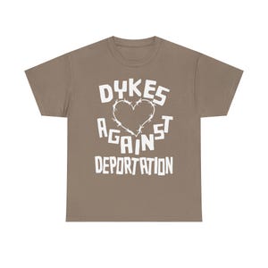 dykes against deportation shirt barbed wire heart tee queer immigrant solidarity abolish ice apparel lesbian protest wear radical pride lgbt migrant justice class war clothing no human illegal activist anti fascist leftist t shirt pride 2025 queer mutual aid detention abolition free them all anti border tee socialist pride unisex graphic the first pride was a riot stonewall t-shirt radical queer liberation no human being is illegal abolish ice abolish borders lesbian anarchist queer anarchism
