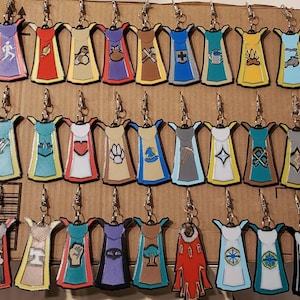 May include: A collection of 30 colorful, hand-painted, enamel cloisonn&eacute; earrings. Each earring features a unique design, including a variety of symbols, animals, and abstract patterns. The earrings are displayed on a brown cardboard background.
