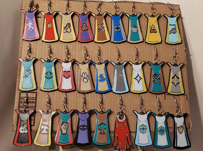 May include: A collection of 30 colorful, hand-painted, enamel cloisonn&eacute; earrings. Each earring features a unique design, including a variety of symbols, animals, and abstract patterns. The earrings are displayed on a brown cardboard background.