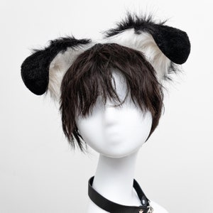 May include: A white and black furry dog ear headband with a black leather choker.