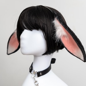 May include: A black wig with a white and pink bunny ear headband and a black leather choker with a silver chain.