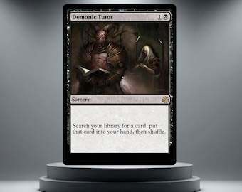 May include: A black Magic: The Gathering card labelled "Demonic Tutor." The card shows a horned demon reading a book, with the word "Sorcery" and instructions below. The card is presented on a grey pedestal.
