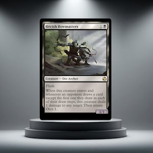 May include: A black Orcish Bowmasters trading card. The card shows an illustration of two Orc archers with bows drawn. Text on the card includes "Creature - Orc Archer" and game instructions. The card is displayed on a grey pedestal.