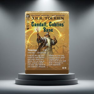 May include: A rectangular trading card featuring an illustration of a wizard holding a staff with fireworks in the background. The text reads J.R.R. Tolkien, Gandalf, Goblins' Bane, Legendary Creature - Avatar Wizard, Flameshape, Sorcery - Adventure.