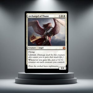 May include: A collectible trading card titled Archangel of Thune featuring an illustration of an angel with large wings and a glowing sword. The card text includes abilities like Flying and Lifelink, with a power and toughness of 3/4.