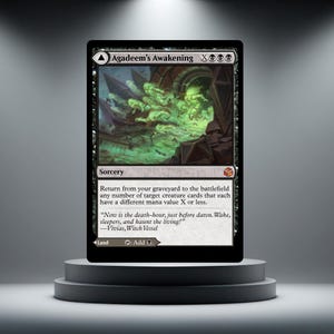 May include: A black Magic: The Gathering card named "Agadeem's Awakening." The card has green and black artwork and text detailing its sorcery function. The card is presented on a grey pedestal.
