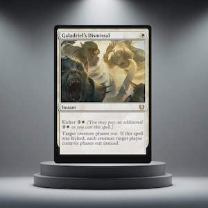 May include: A Magic: The Gathering card titled "Galadriel's Dismissal" on a black background. The card features a fantasy illustration of creatures and text. The card is displayed on a gray, tiered plinth.