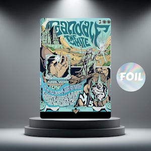 May include: A fantasy-themed trading card with a wizard and the text "Gandalf the White." The card has a blue, teal, and beige colour scheme with a foil sticker. The card is displayed on a grey pedestal.